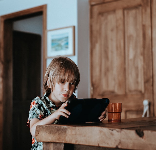 young boy using ipad