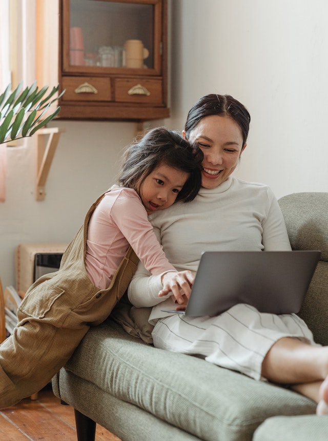 mom on ipad with child